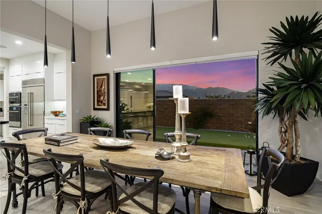 a view of a dining room with furniture and a potted plant