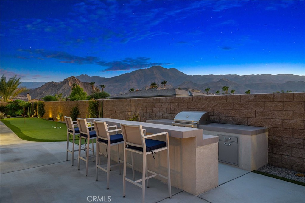 80380 Old Rnch Trail North La Quinta, CA 92253 - Photo 30 of 35 a view of a chairs and table in patio with a lake view