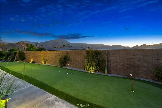 a view of grassy field with mountain in the background