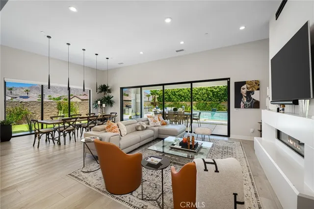 a living room with fireplace furniture and a large window