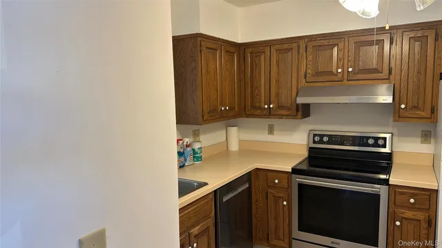 a kitchen with appliances cabinets and a counter top space