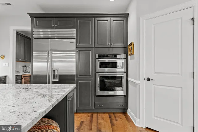 a view of a dining room with furniture a chandelier and wooden floor