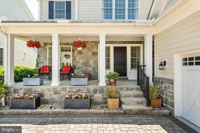 a front view of a house with outdoor seating