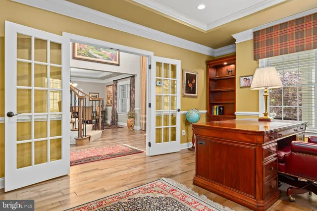 a living room with a large window and a rug