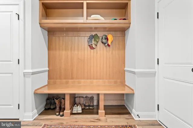 a view of a hallway with wooden floor and stairs