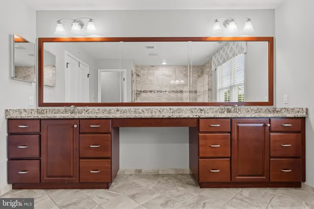 a view of a bedroom with furniture and window