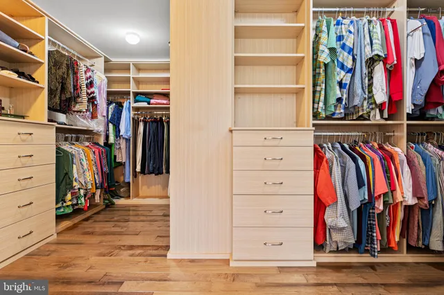 a bedroom with three beds and a chandelier