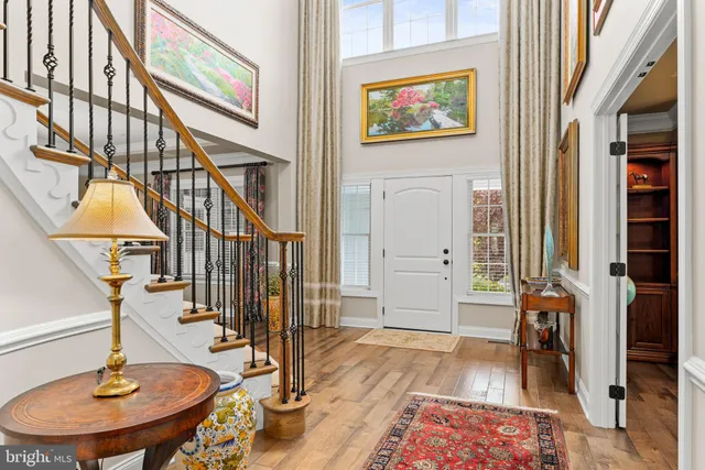 a large kitchen with stainless steel appliances granite countertop a lot of counter space and a wooden floors