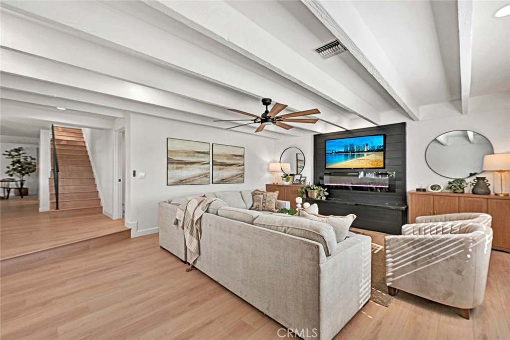 5331 Cerulean Avenue Garden Grove, CA 92845 - Photo 15 of 44 a living room with furniture a flat screen tv and a fireplace