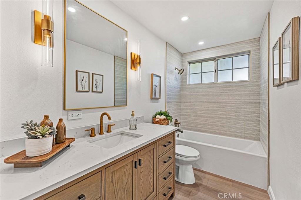 5331 Cerulean Avenue Garden Grove, CA 92845 - Photo 18 of 44 a bathroom with a granite countertop sink a toilet and a bathtub