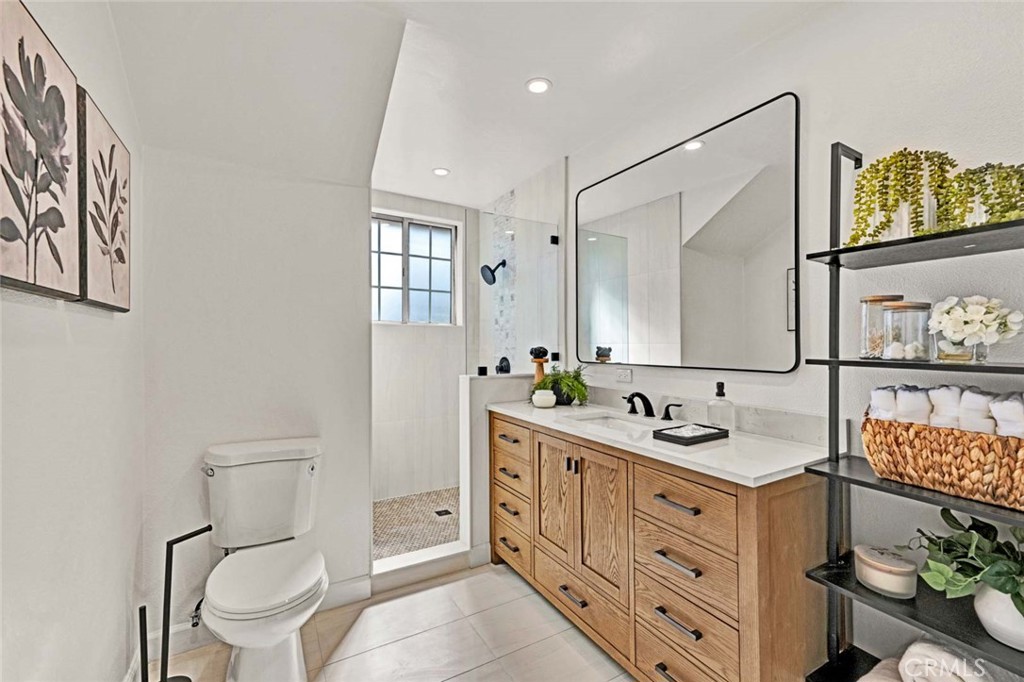 5331 Cerulean Avenue Garden Grove, CA 92845 - Photo 23 of 44 a bathroom with a toilet sink and mirror