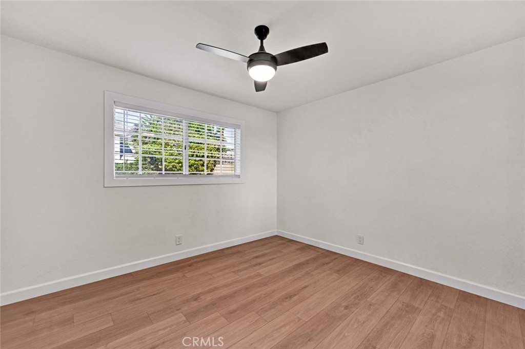 5331 Cerulean Avenue Garden Grove, CA 92845 - Photo 29 of 44 an empty room with wooden floor and windows