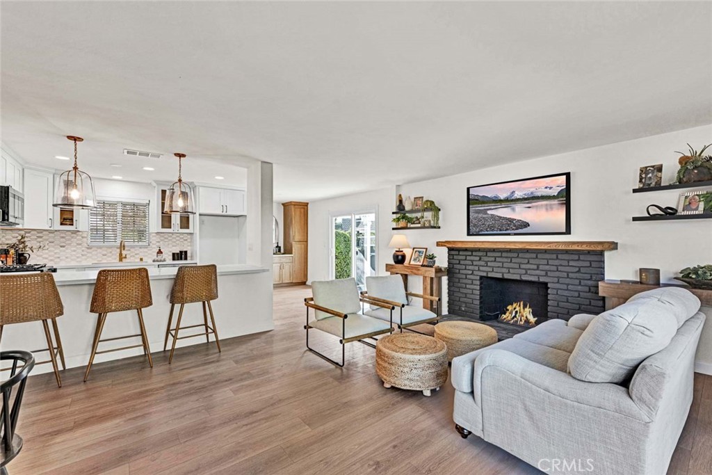 5331 Cerulean Avenue Garden Grove, CA 92845 - Photo 3 of 44 a living room with furniture wooden floor and a fireplace