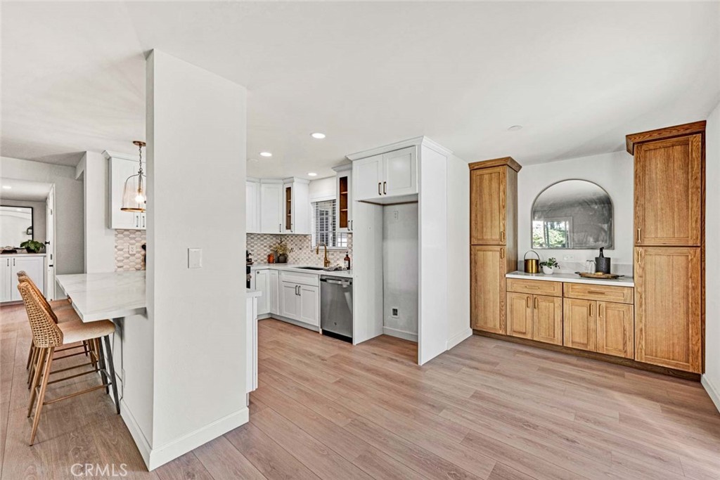 5331 Cerulean Avenue Garden Grove, CA 92845 - Photo 6 of 44 a kitchen with white cabinets and stainless steel appliances