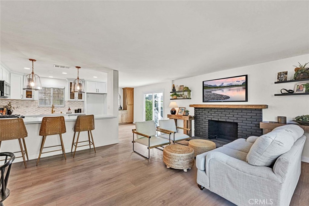 5331 Cerulean Avenue Garden Grove, CA 92845 - Photo 7 of 44 a living room with furniture wooden floor and a fireplace