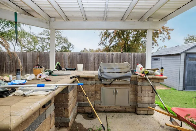 a view of a patio with a table and chairs in the patio