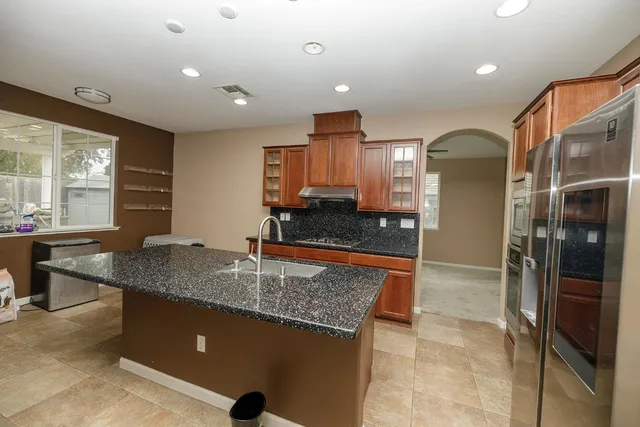 a kitchen with stainless steel appliances granite countertop sink and cabinets