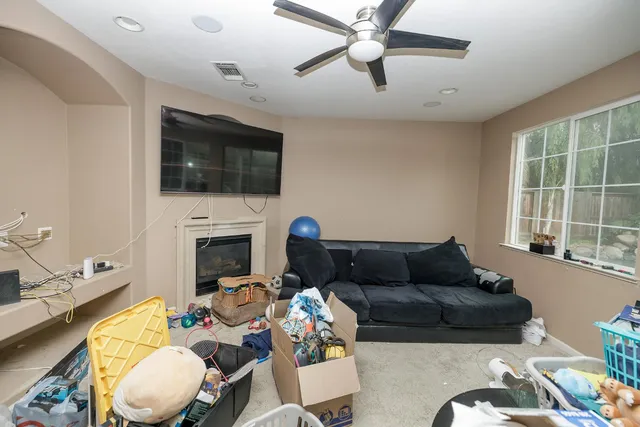 a living room with furniture a fireplace and a flat screen tv
