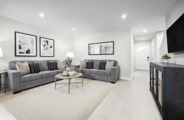 a living room with furniture and a flat screen tv