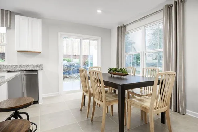 a view of a dining room with furniture and a window