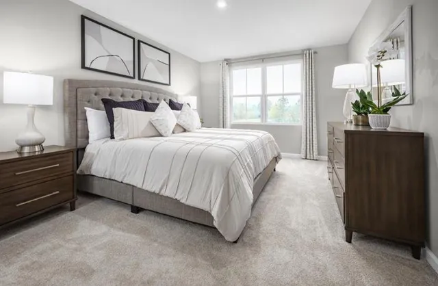 a spacious bedroom with a bed and window with lamp