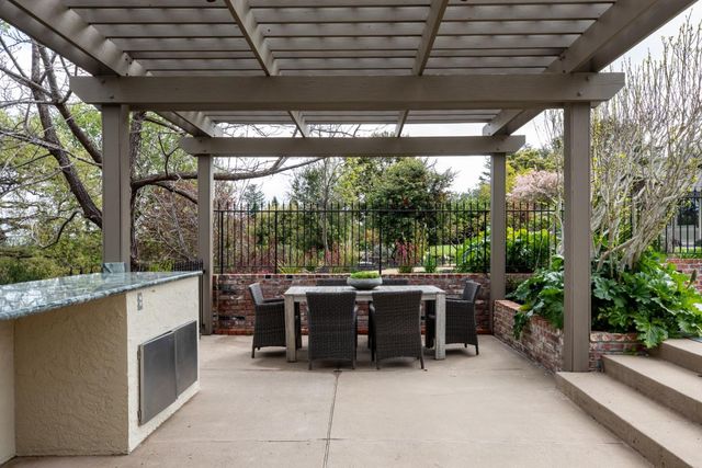 a view of a patio with chairs and a backyard