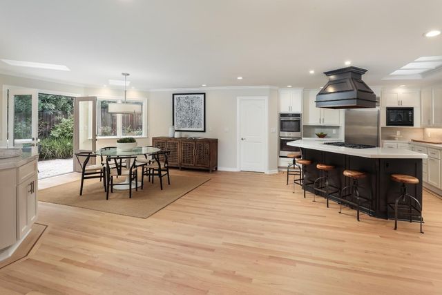 a dining room with furniture and wooden floor