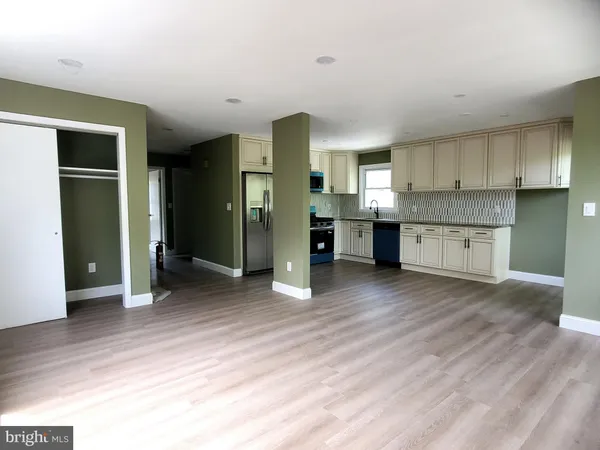 a view of a kitchen with a sink and a refrigerator