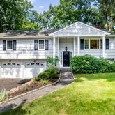 a front view of a house with a yard and porch
