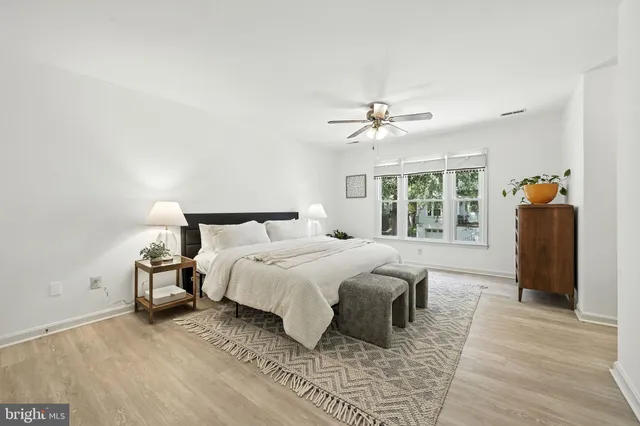 a bedroom with a large bed and a chandelier