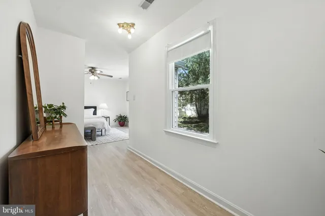 a bedroom with a bed and a potted plant