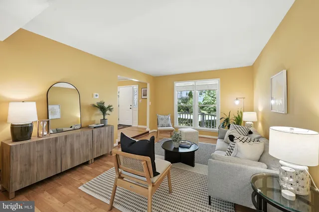 a living room with furniture a window and a table