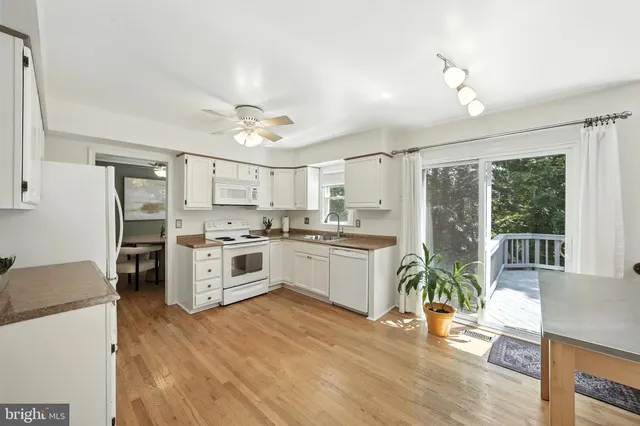 a kitchen with a stove a refrigerator and a stove top oven
