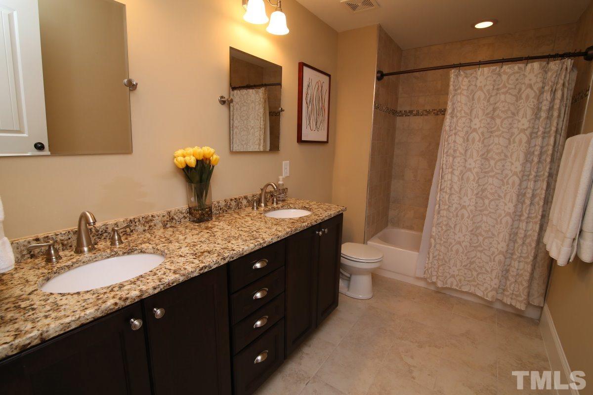 315 Georgetown Road Raleigh, NC 27608 - Photo 20 of 24 Granite, dual sinks, tiled floor and shower/bath.