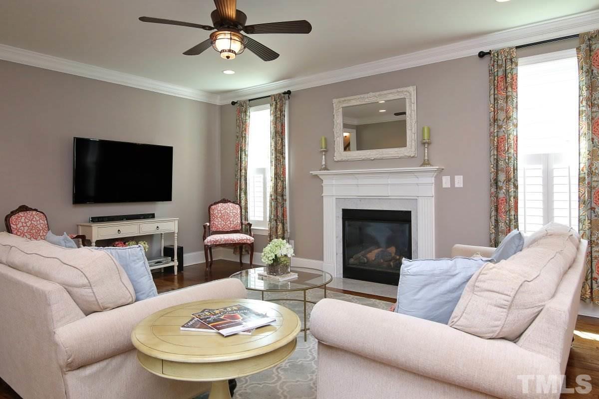 315 Georgetown Road Raleigh, NC 27608 - Photo 8 of 24 Perfect family room w/ceiling fan, fireplace and hardwoods. Crown moldings and neutral paint.