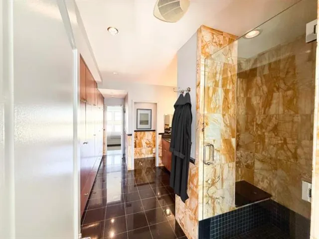 a spacious bathroom with a double vanity sink a mirror and a shower