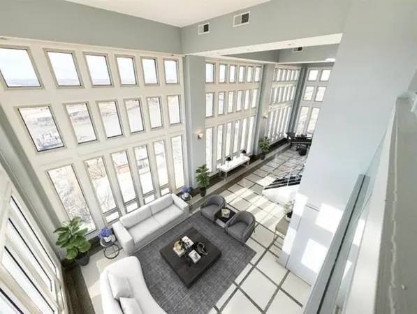 a living room with furniture and a floor to ceiling window