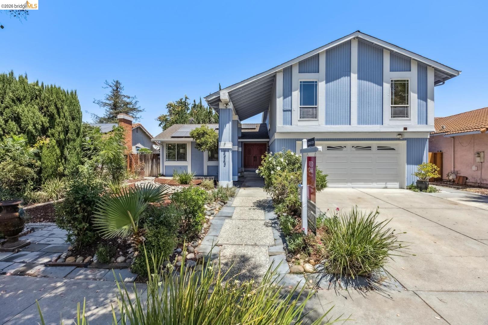 a front view of a house with garden