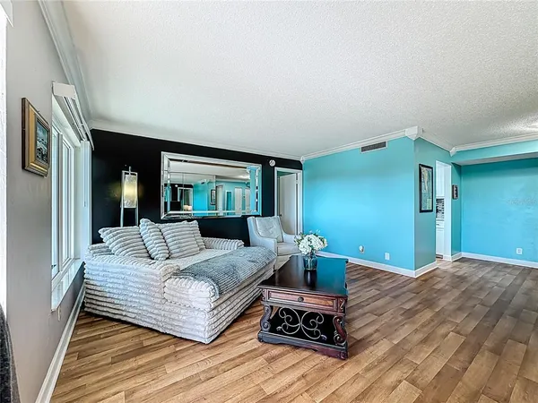 a bedroom with a bed wooden floor and lamp