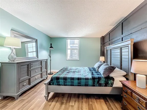 a bedroom with a bed and a dresser