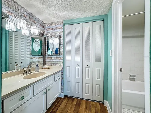a bathroom with a sink a mirror and a shower