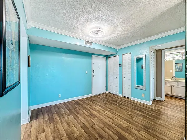 a view of a big room with wooden floor and windows