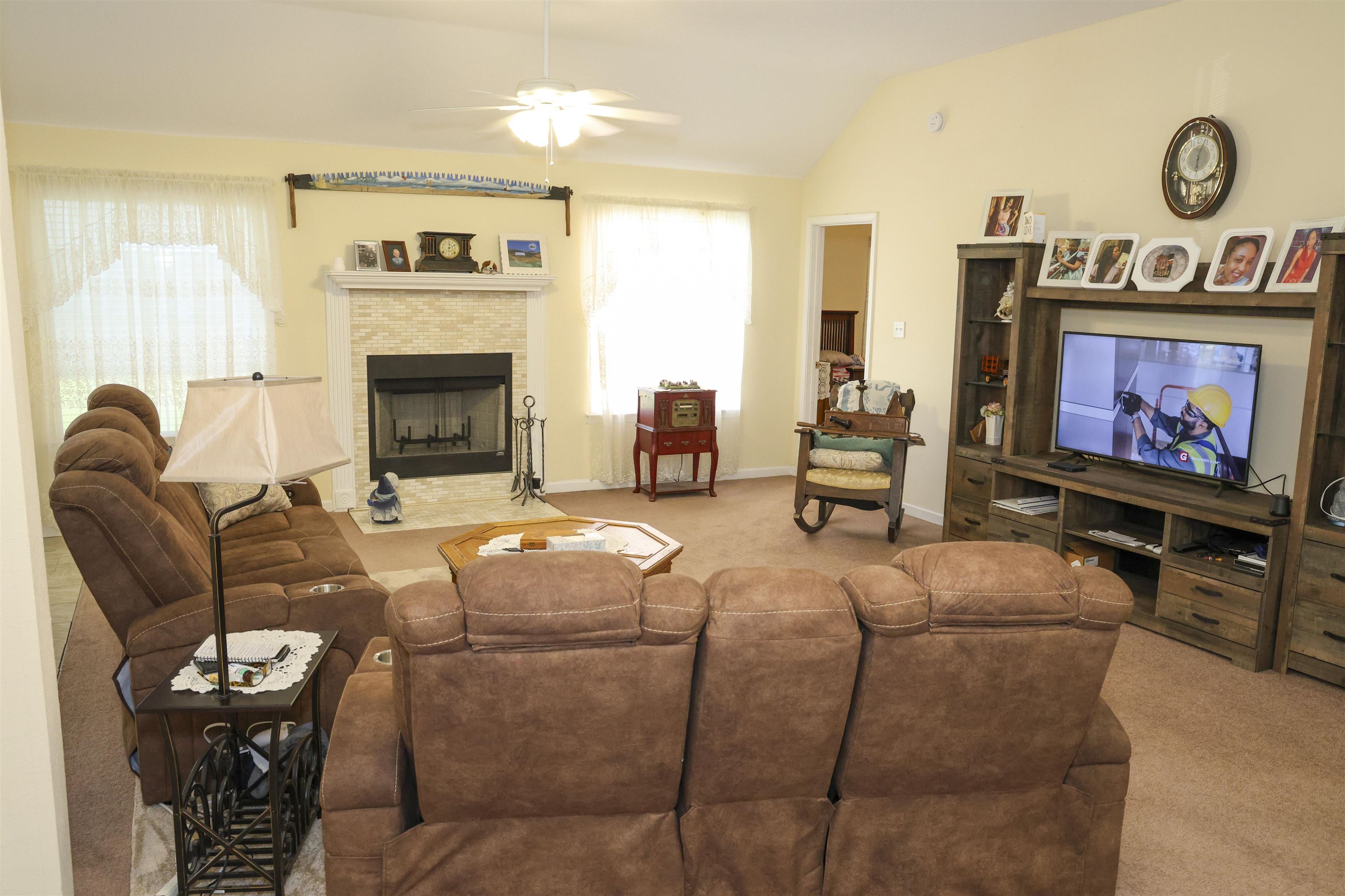 6626 Finch Road Memphis, TN 38141 - Photo 5 of 14 Living area featuring vaulted ceilings, a ceiling fan, and carpeted flooring