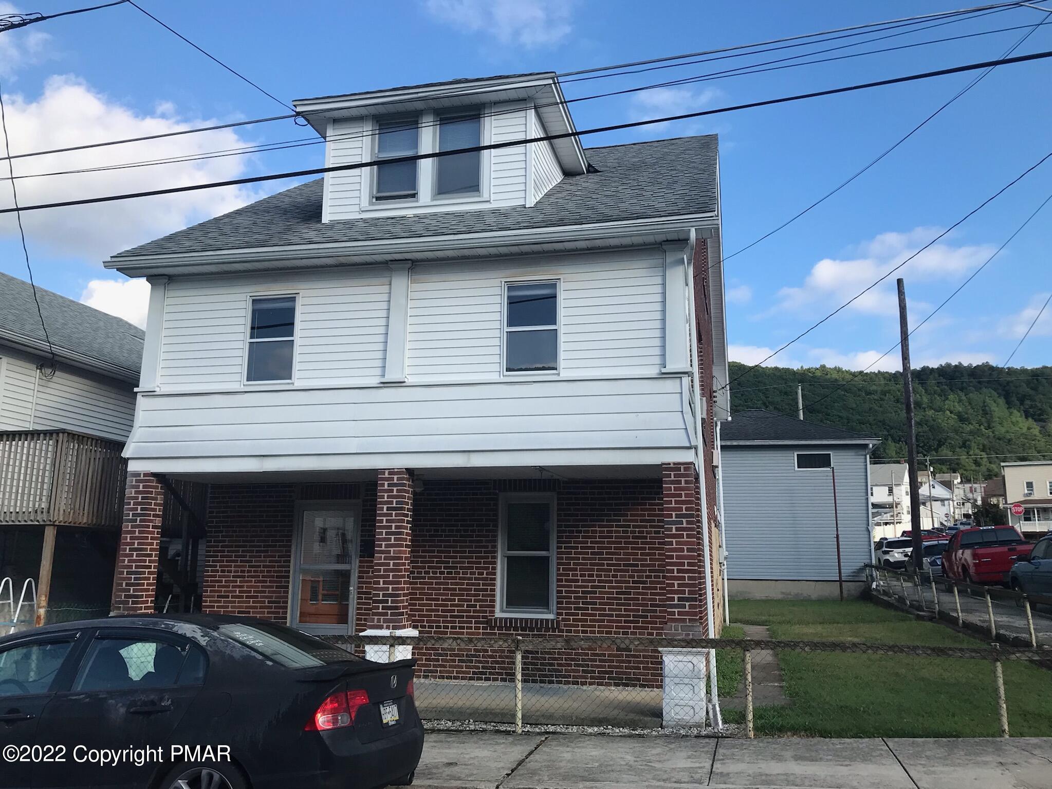 a front view of a house with parking
