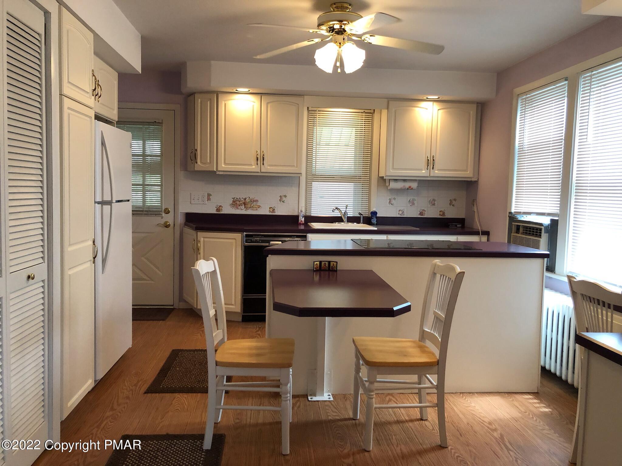 51 Rhume Street Nesquehoning, PA 18240 - Photo 3 of 17 a kitchen with kitchen island a dining table chairs cabinets and stainless steel appliances
