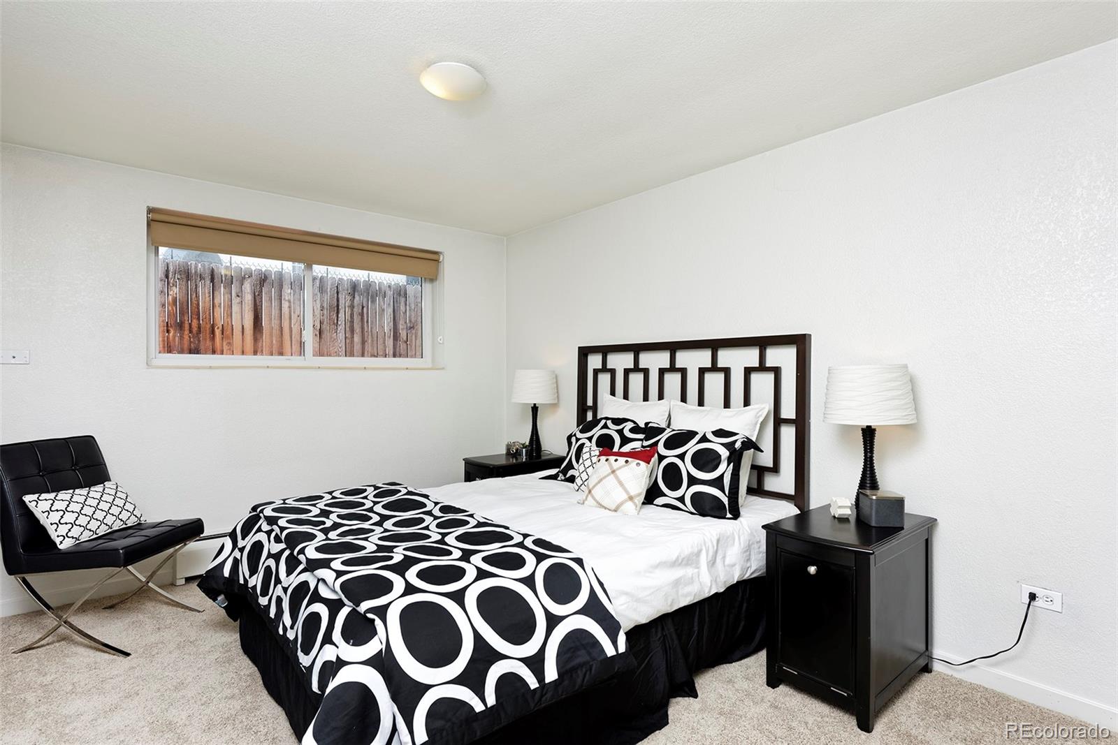 75 Emerson Street, Unit 103 Denver, CO 80218 - Photo 12 of 19 a bedroom with a bed and wooden floor