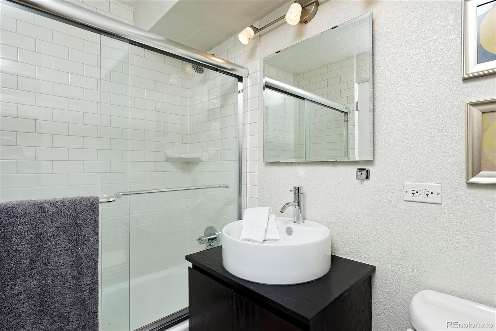 75 Emerson Street, Unit 103 Denver, CO 80218 - Photo 14 of 19 a bathroom with a sink and mirror