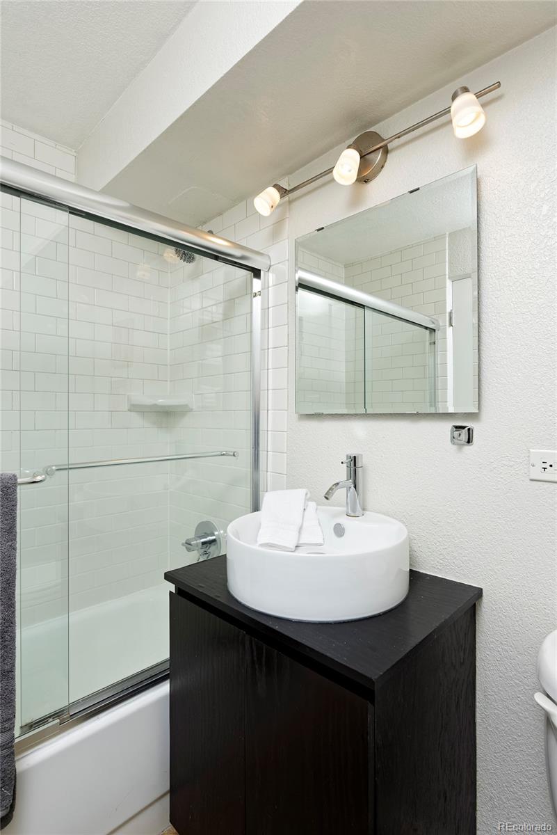 75 Emerson Street, Unit 103 Denver, CO 80218 - Photo 15 of 19 a bathroom with a sink and a mirror