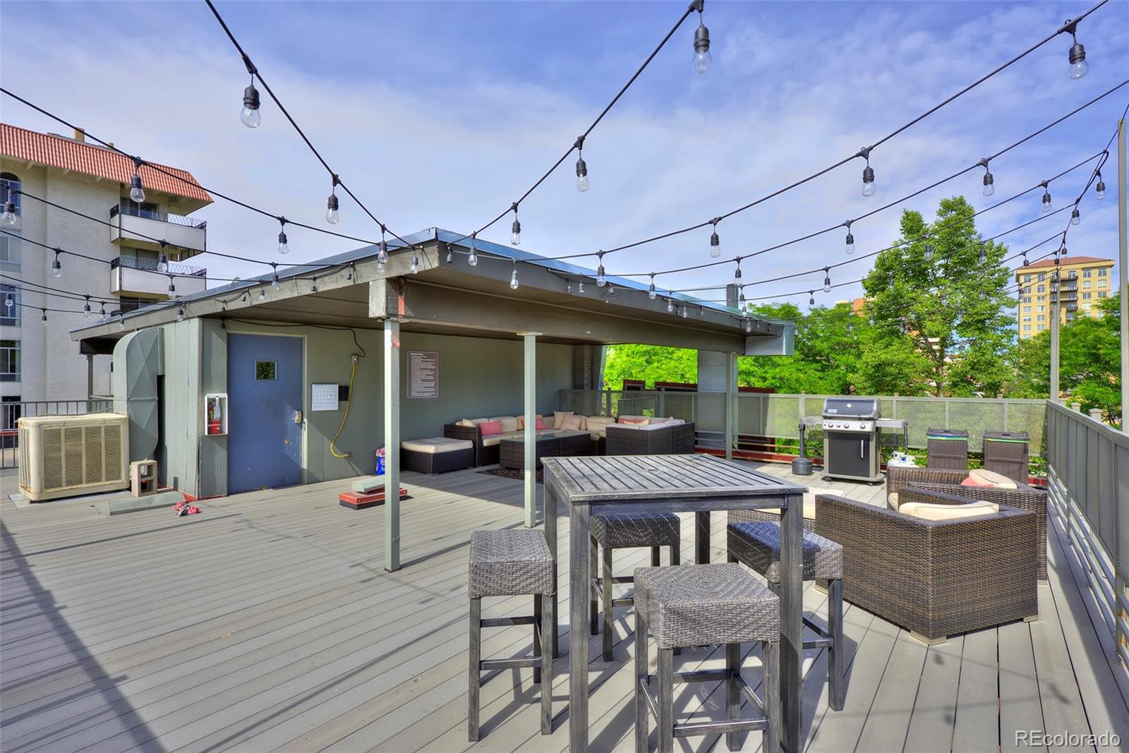 75 Emerson Street, Unit 103 Denver, CO 80218 - Photo 16 of 19 a view of a patio with couches table chairs and floor to ceiling window