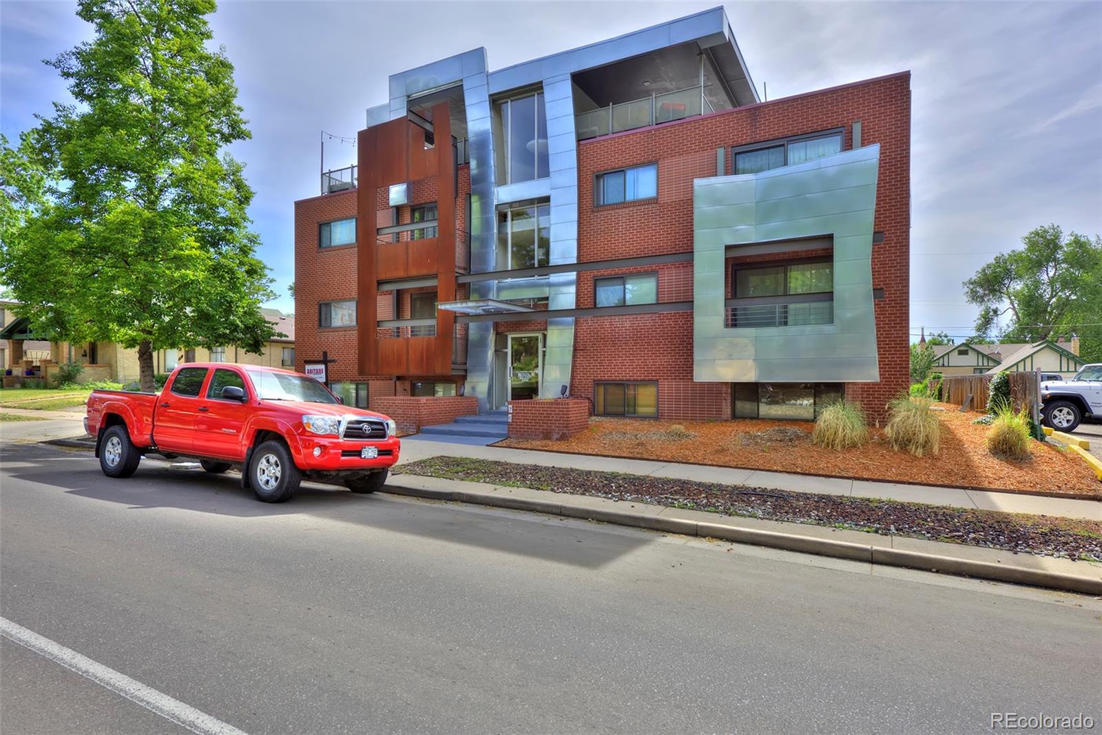 75 Emerson Street, Unit 103 Denver, CO 80218 - Photo 19 of 19 a view of a street that has couple of cars parked on the road